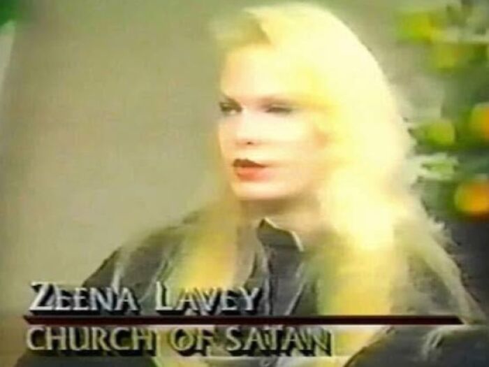 Woman with long blonde hair discussing occult topics in an interview setting related to Church of Satan themes