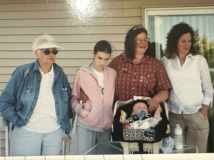 Family photo with mixed expressions and awkward poses, capturing a moment often laughed at in online family photos.