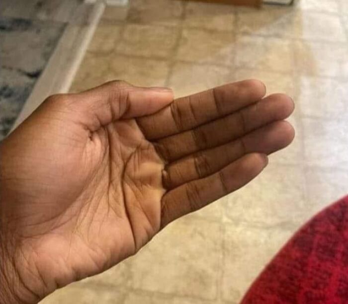 Hand showing a hidden smaller hand inside the palm, humorously illustrating pleasures of the occult out of context.