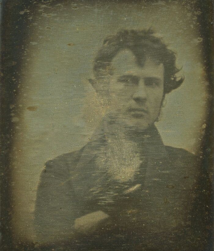 Early black and white portrait of a man with sideburns, showcasing rare photos from the time when photography was new.