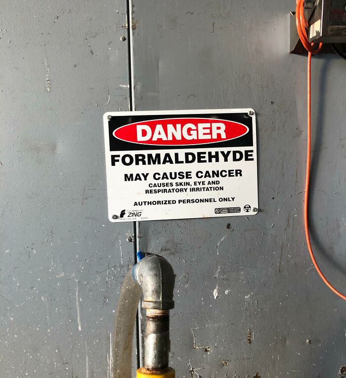 Danger sign warning about formaldehyde exposure in a workplace, highlighting unsettling conditions workers face.