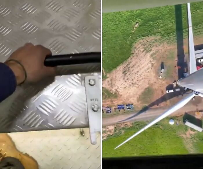 Worker gripping a handle inside a wind turbine tower with an aerial view of the turbine blades and ground below.