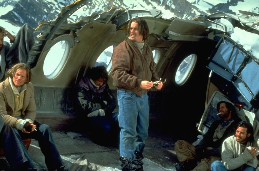 Survivors inside a crashed plane in snowy mountains, a scene from a movie based on true stories that feel impossible to believe.