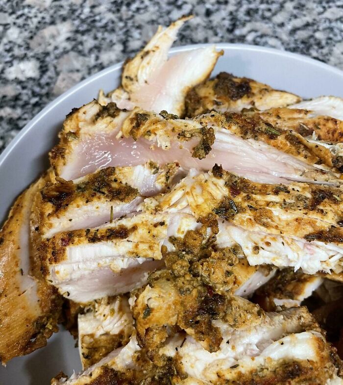 Undercooked seasoned chicken pieces in a bowl, a cursed and disgusting picture of food that might make you eeeeew