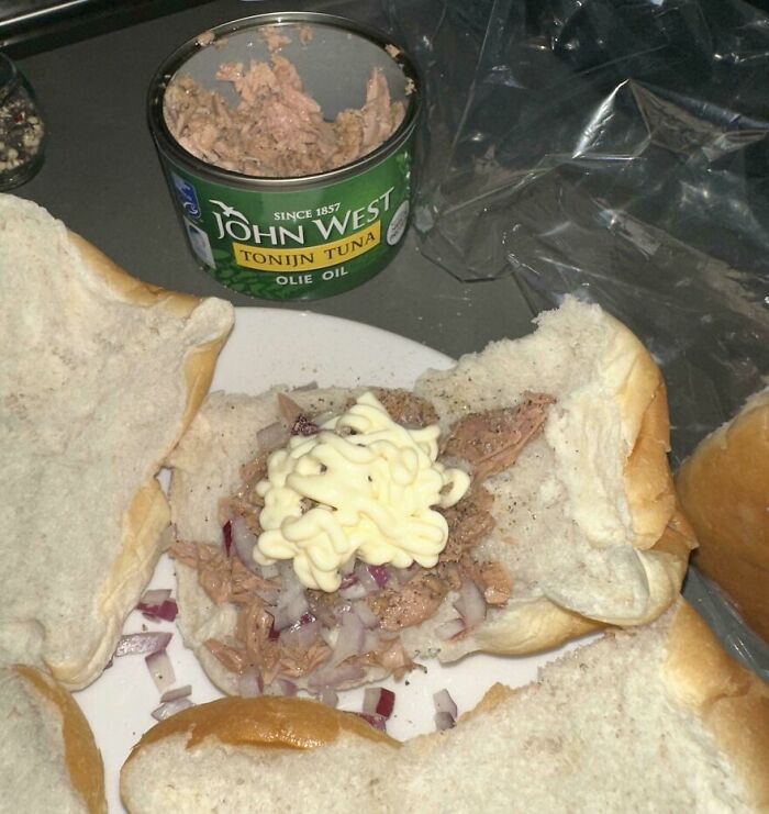 Open sandwich with canned tuna, chopped onions, and mayonnaise on white bread, showing a cursed and disgusting food picture.