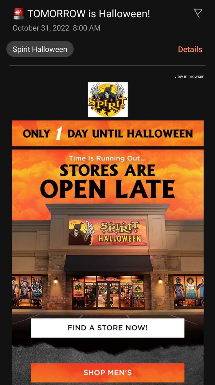 Spirit Halloween store at dusk with open late sign and promotion for last day shopping before Halloween fails.
