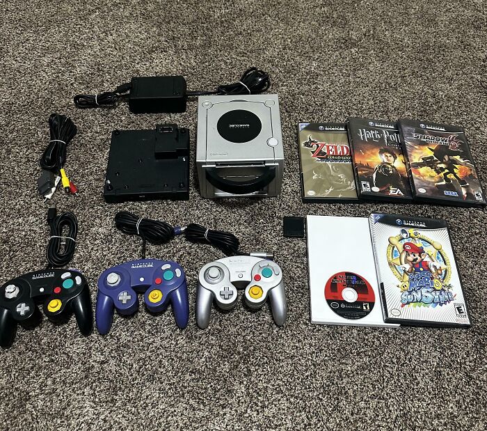 Vintage GameCube console with controllers, cables, and classic game discs, a dumpster diving treasure find.