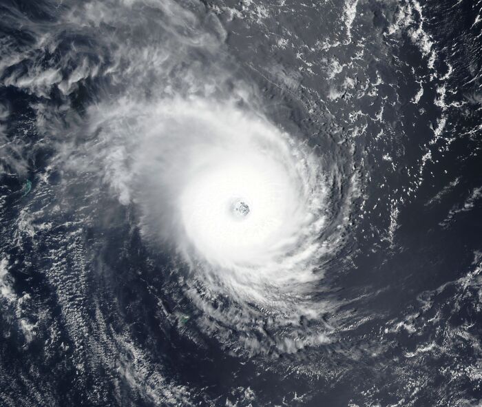 Satellite view of a massive hurricane with a clear eye, showcasing incredible weather records and powerful planetary forces.