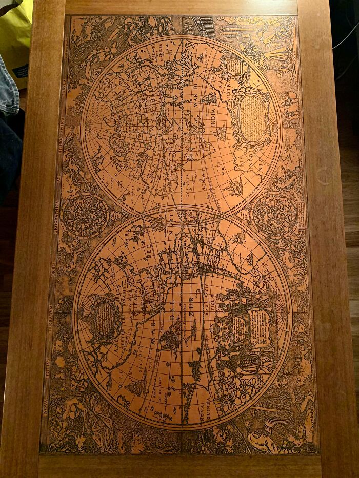 Vintage world map design on wooden table, one of 80 lucky thrift store shoppers' jackpot finds.