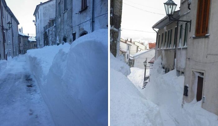Snow piled high between narrow streets in a residential area showcasing incredible weather records with heavy snow accumulation.