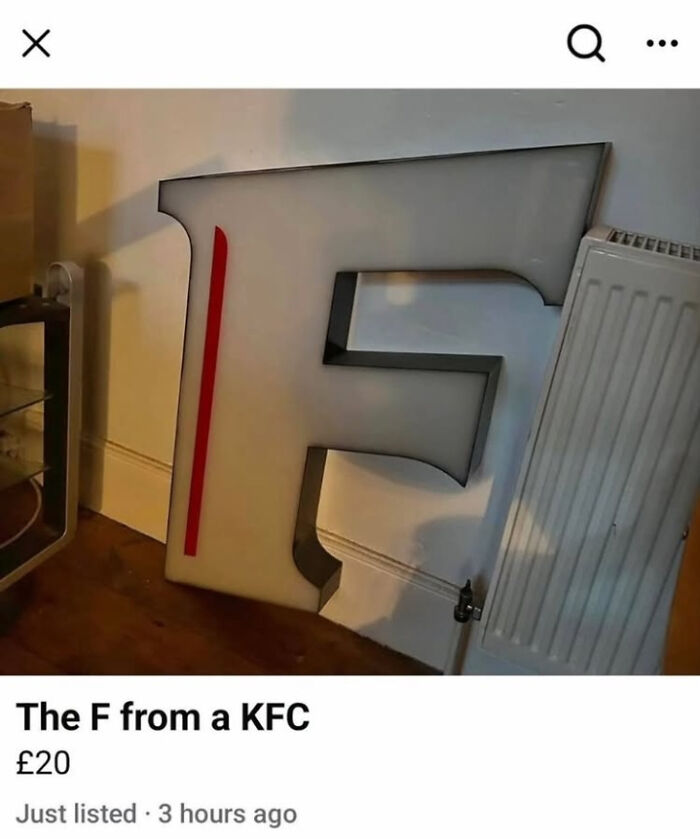 Large F letter sign from KFC resting against a wall next to a radiator, featured in funny pictures that go hard.