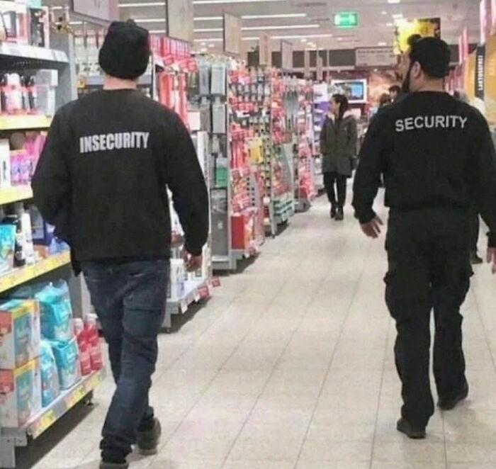 Two men walking in a store aisle wearing jackets labeled insecurity and security, a humorous picture going hard with people chuckling.