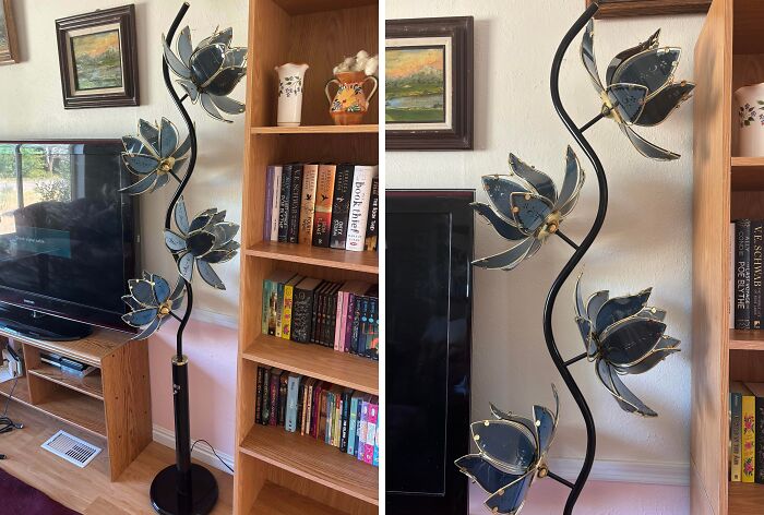 Thrift store jackpot find featuring a unique vintage floral floor lamp next to a wooden bookshelf and TV.