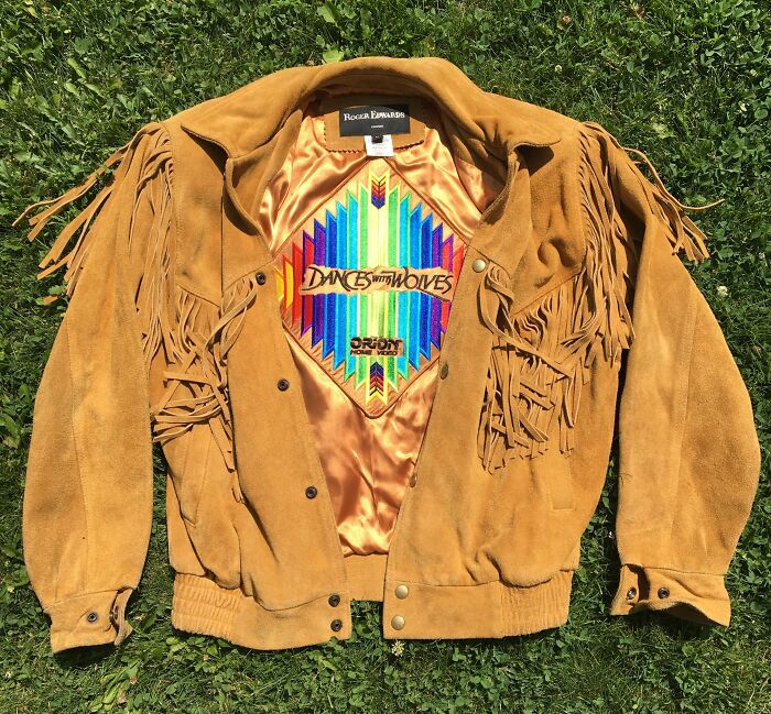 Vintage tan suede fringe jacket with colorful embroidered lining, a perfect thrift store jackpot find for lucky shoppers.