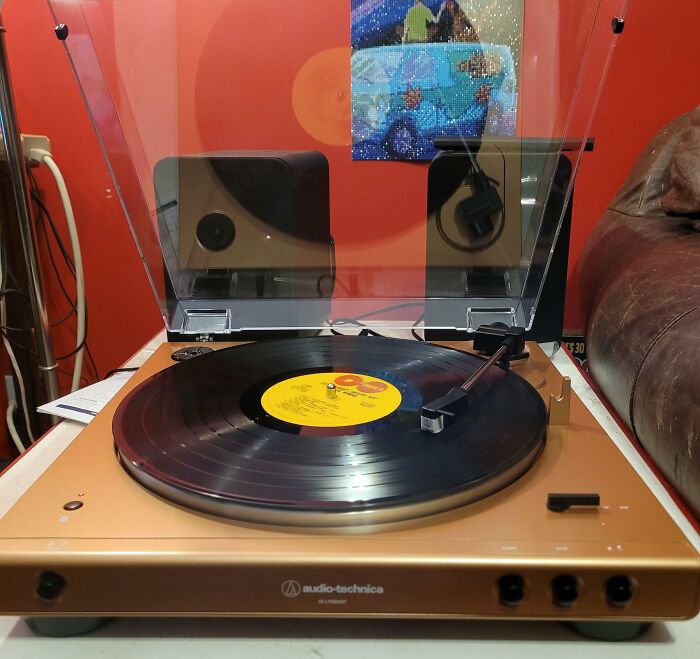Vintage Audio-Technica turntable playing a vinyl record found by lucky thrift store shoppers Jackpot.