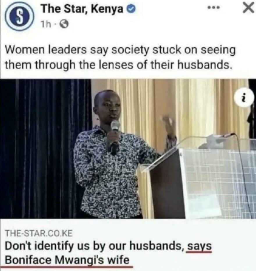 Woman leader speaking at a podium addressing society's perception of women through the lens of their husbands.