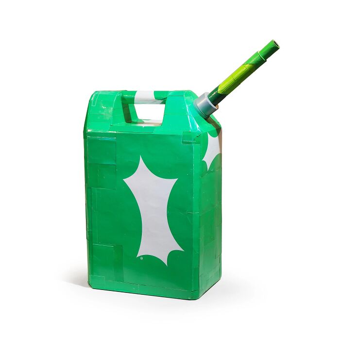 Green jerrycan sculpture made from waste materials, showcasing witty commentary on modern life by an innovative artist.