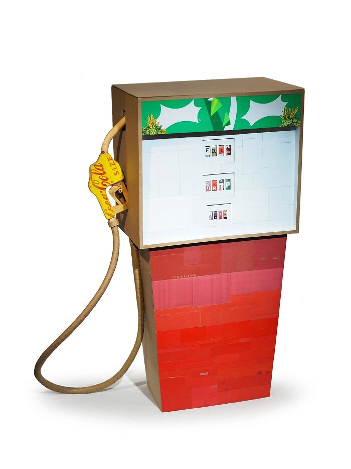 Artistic fuel pump sculpture made from waste materials, showcasing witty commentary on modern life through recycled art.