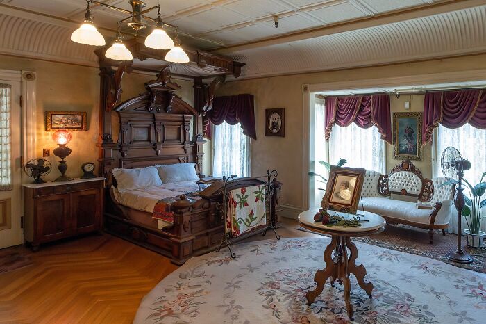 Victorian bedroom with antique wooden bed and vintage furniture in one of the spooky destinations for Halloween visitors. Victorian bedroom with antique wooden bed and vintage furniture in one of the spooky destinations for Halloween visitors.