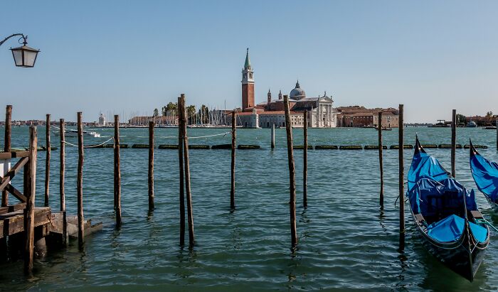 Venice waterfront with gondolas and historic buildings, a top spooky destination known for haunting atmospheres this Halloween.
