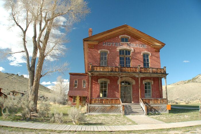 Abandoned spooky brick hotel in a remote desert area, a haunted destination for Halloween travelers.