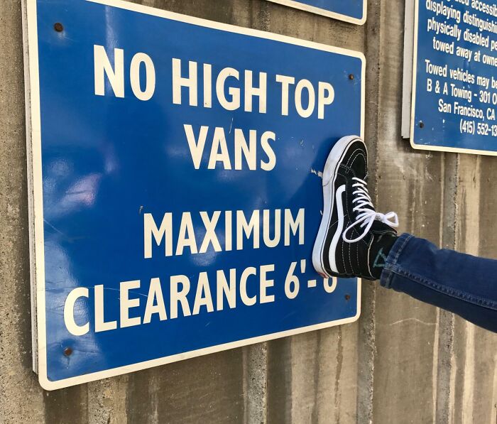 Person humorously kicking a "No high top vans" sign, illustrating unhinged pics of people doing exactly what they were asked to do.
