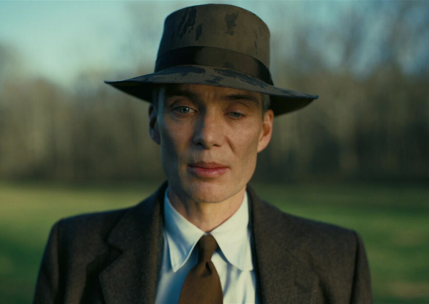 A man in a vintage hat and suit stands outdoors, representing 2024 pop culture moments that shocked readers.