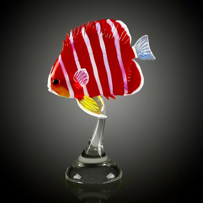 Red and white striped glass sculpture of a tropical fish, showcasing stunning ocean life in vibrant detail.