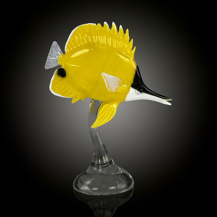 Yellow and black glass sculpture of an ocean fish on a clear glass stand showcasing stunning glass sculptures.