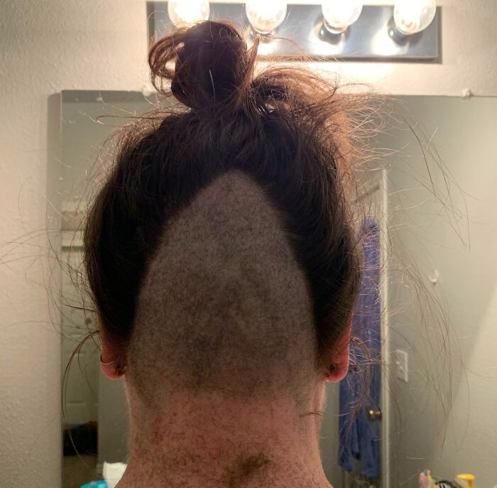 Back of a person's head showing a tragically uneven haircut, highlighting a funny and tragic hair accident. Back of a person's head showing a tragically uneven haircut, highlighting a funny and tragic hair accident.