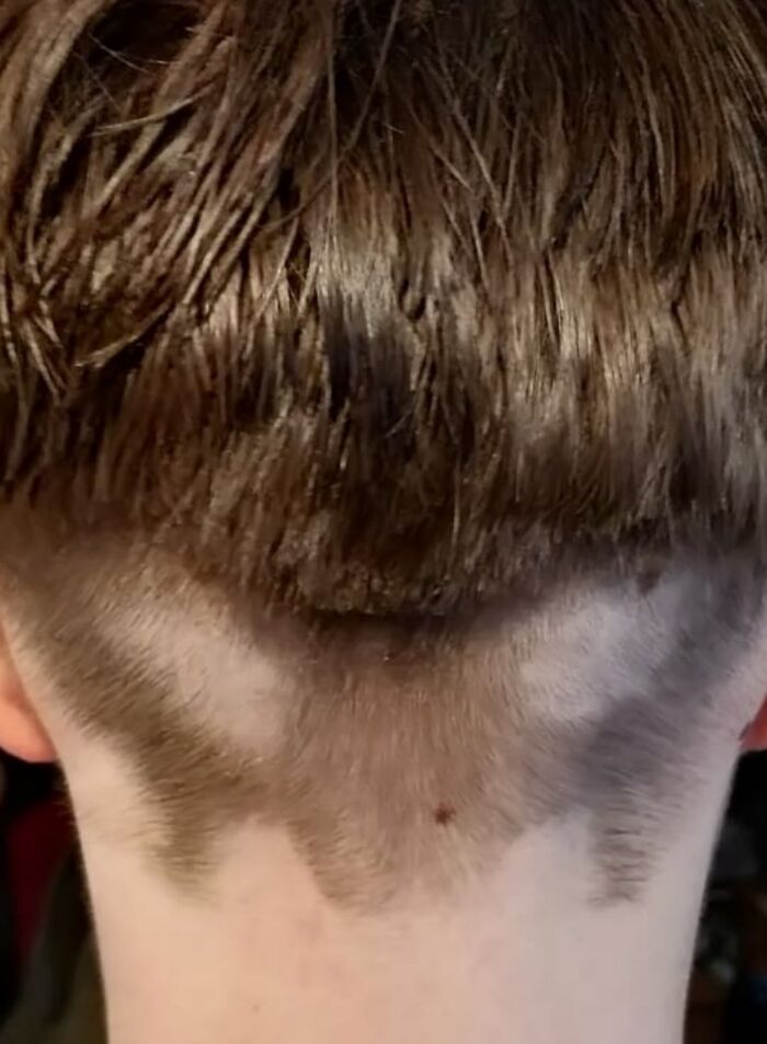 Close-up of a hairstyle showing a tragically uneven and funny hair accident at the nape of the neck.