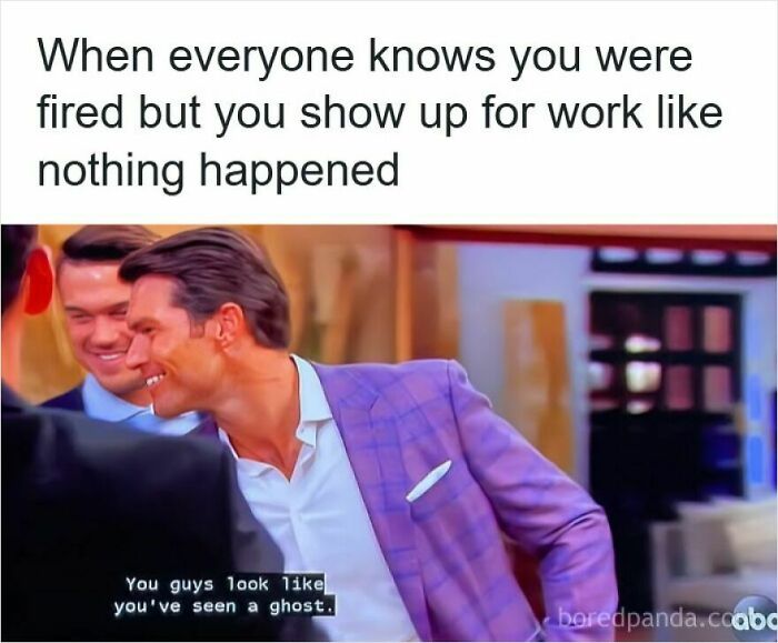 Man in purple blazer smirking while coworkers react, illustrating funny memes about getting laid off humor and awkwardness.