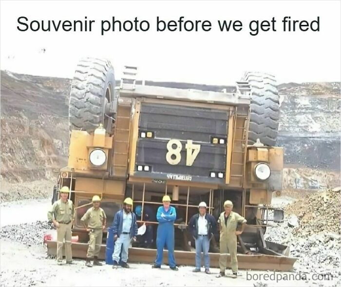 Group of workers posing in front of an overturned truck, illustrating funny memes about getting laid off and job loss humor.