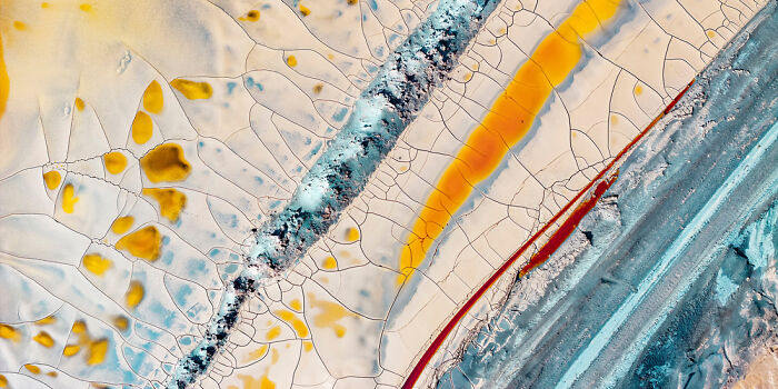 Abstract aerial view of c*****d earth and colorful lines showcasing panoramic masterpieces from the Epson Pano Awards 2025.