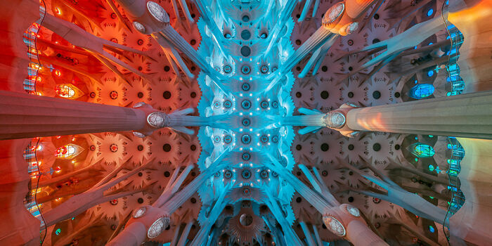 Panoramic masterpiece of a vibrant cathedral ceiling with contrasting warm red and cool blue lighting details.