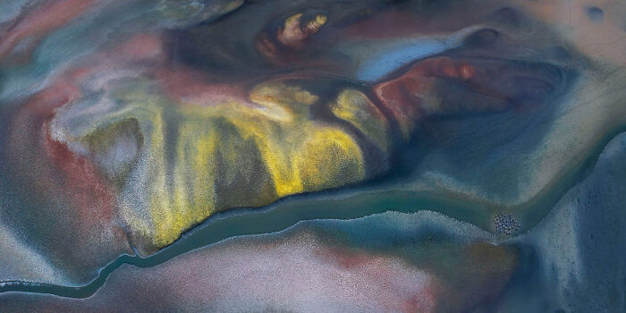 Aerial view of colorful, abstract landscape with winding river, featured in Epson Pano Awards 2025 panoramic masterpieces.