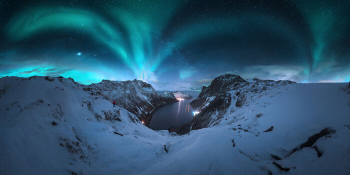 Snowy mountain panorama under vibrant northern lights showcasing stunning panoramic masterpiece winning the Epson Pano Awards 2025.