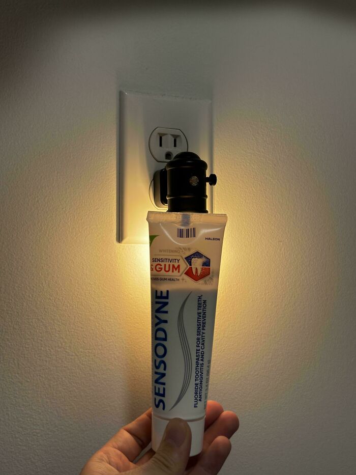Toothpaste product misleadingly packaged as a light bulb, highlighting deceptive marketing in product packaging.