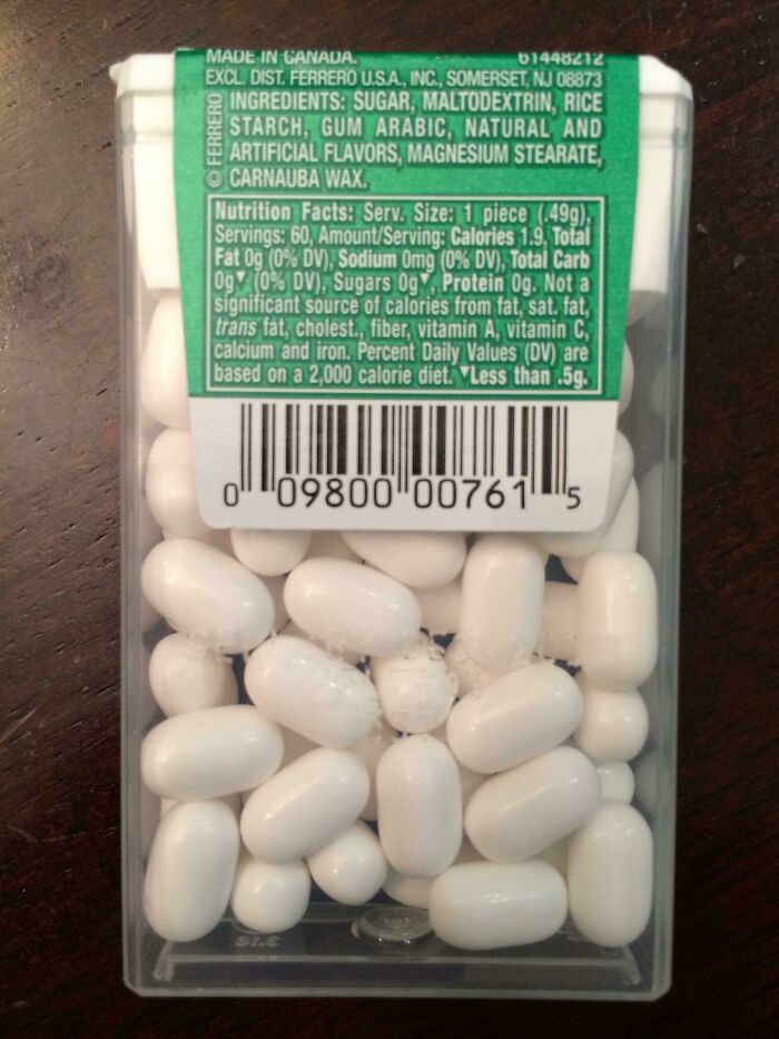 Clear plastic packaging filled with white mints and a detailed nutrition label, showing misleading packaging by companies.