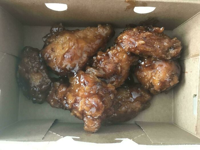 Box of glazed fried chicken wings, showcasing a tasty example of strangers spreading kindness and faith in humanity restored.