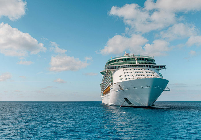 Large cruise ship on calm ocean under blue sky representing a wedding not on American soil dilemma.