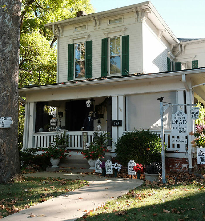 Halloween decorations with skeletons and tombstones outside a historic house in viral footage of bizarre neighbor attack.
