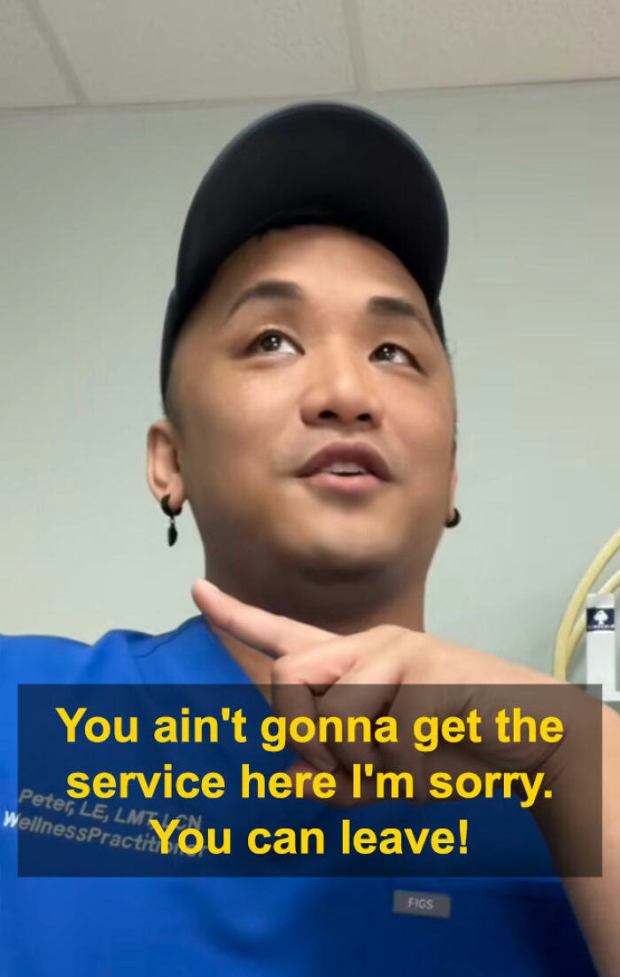 Aesthetician in blue scrubs and cap pointing while addressing a man during a viral interaction about a booking lie. Aesthetician in blue scrubs and cap pointing while addressing a man during a viral interaction about a booking lie.