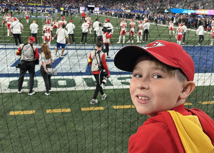 Young boy in a red cap at a football stadium amid Kansas City Karen viral incident surrounding a headband dispute. Young boy in a red cap at a football stadium amid Kansas City Karen viral incident surrounding a headband dispute.