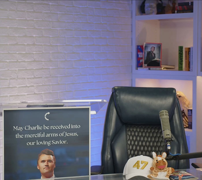 Home office setup with a microphone and a sign referencing Charlie Kirk, related to a controversial homework assignment. Home office setup with a microphone and a sign referencing Charlie Kirk, related to a controversial homework assignment.