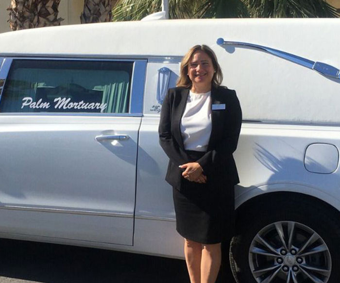 Woman in black suit standing in front of a white funeral car, related to urgent investigation of human remains in Las Vegas desert Woman in black suit standing in front of a white funeral car, related to urgent investigation of human remains in Las Vegas desert