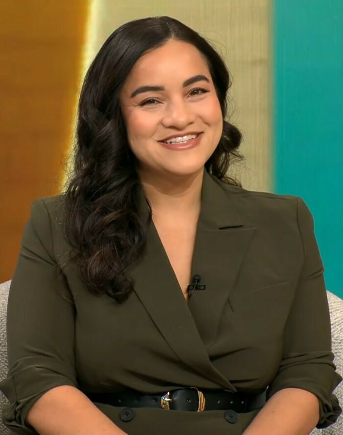 Female professor smiling during interview, sparking debate after evidence-based decision to stop dating men. Female professor smiling during interview, sparking debate after evidence-based decision to stop dating men.