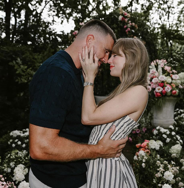 Couple embracing in a garden filled with flowers, relating to Tradwife and Taylor Swift fans reacting after Travis Kelce autograph. Couple embracing in a garden filled with flowers, relating to Tradwife and Taylor Swift fans reacting after Travis Kelce autograph.