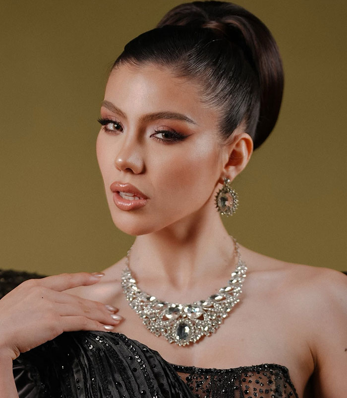 Miss Panama wearing elegant jewelry and makeup, posing gracefully in a glamorous black outfit onstage. Miss Panama wearing elegant jewelry and makeup, posing gracefully in a glamorous black outfit onstage.