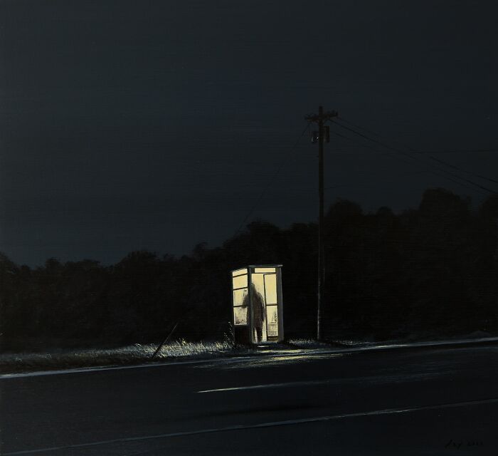 Dark night scene with a solitary figure in a lit phone booth, capturing the space between dreams and reality.